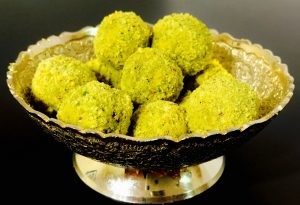 dates and pistachio balls in silver serveware