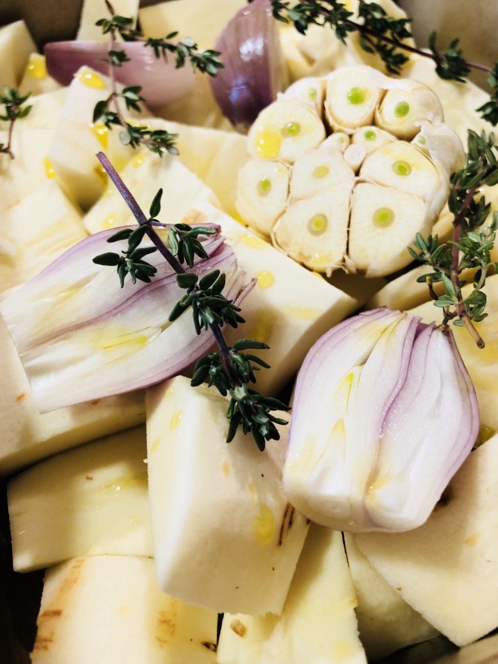 Parsnips shallots garlic thyme olive oil and white wine in a baking dish