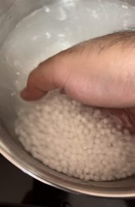 Scoop Rinsed Sabudana Out using hands