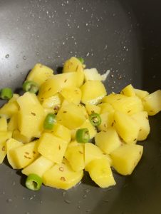 Potatoes cumin and green chilies in ghee